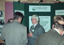 Event in performance theatre lobby. Not a Theatre event. Chilliwack campus manager Erling Close speaks with visitors. (Some sort of career fair or student recruiting event based on what can be read on the displays.)