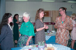 Nursing graduation tea. Lab coordinator Joanna Hirnschall is third from left (white hair). Nursing instructor Lynn Kirkland Harvey is on theright in floral suit.